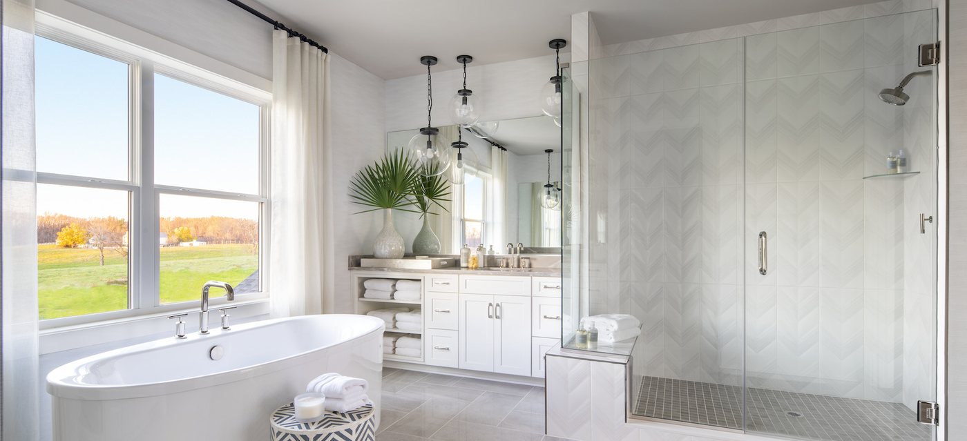 Bright remodeled bathroom with walk-in shower and freestanding tub